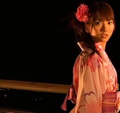 Breathtaking Japanese vixen in a floral kimono with a flower in her hair