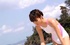 Cute Asian teeny in a white swimsuit on the beach