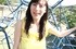 Slim Japanese coed in a yellow top on the kids' palyground
