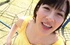Slim Japanese coed in a yellow top on the kids' palyground