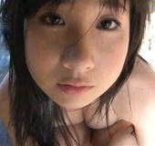 Busty pigtailed teeny from Japan in a floral bikini posing outdoors