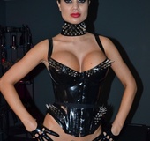 Pervert brunette mistress in a latex body flogging bond and gagged dude