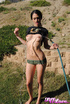 Lovely shiela in a black shirt hosing herself down outdoors.