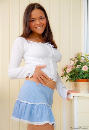 Cute teen in a white blouse and blue skirt dipping digits. - Picture 3