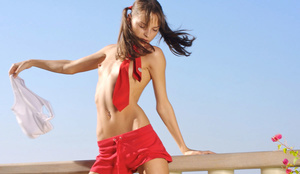 Bony broad in a red neckerchief, red shorts, white shirt and blue panties strippig outdoors. - Picture 7