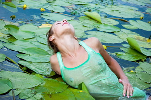 Scrawny teen in a green shirt and white panties stripping in a lily pond. - Picture 5