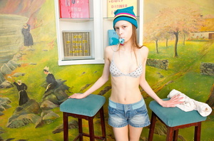 Lean lass in a bonnet getting naked on a blue stool. - Picture 5