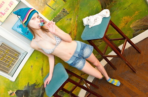 Lean lass in a bonnet getting naked on a blue stool. - Picture 6