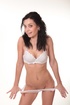 Brunette teeny takes off her jeans sorts and top to pose in her whit lingerie