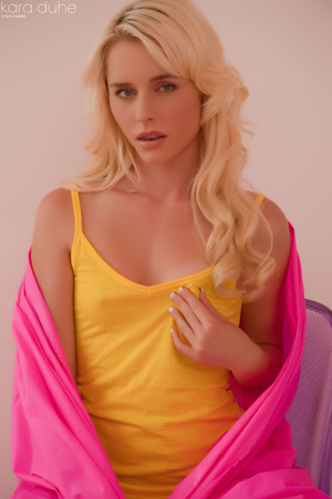 Temptress in a yellow top seduces  with her tongue. She also gives a peek of a breast and a  pussy. - Picture 2