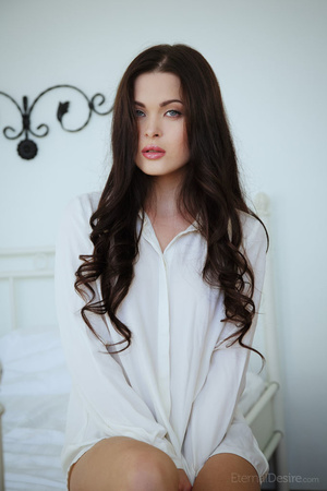 Tender brunette girl in a white shirt po - Picture 1