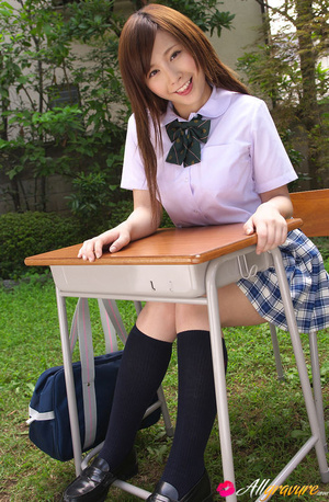 Chick in her school threads poses on a desk in the garden. - Picture 6