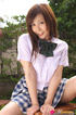 Chick in her school threads poses on a desk in the garden.