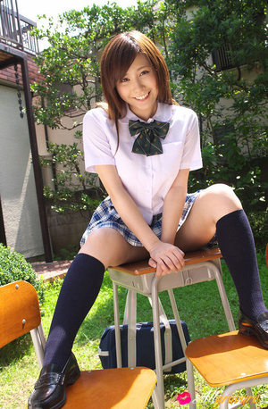 Chick in her school threads poses on a desk in the garden. - Picture 10