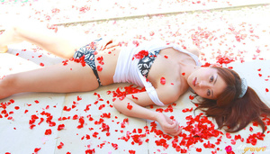 Broad in a bandeau bikini poses on some red flower petals. - XXXonXXX - Pic 10