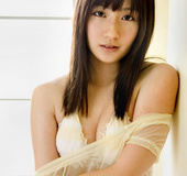 Strumpet in a sheer chemise and white lingerie poses by the door.