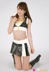 Race queen in black boots and skirt models in front of a white background.
