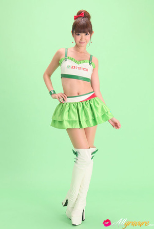 Bird in a green skirt and white boots posing in front of a green background. - XXXonXXX - Pic 1