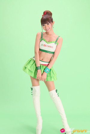 Bird in a green skirt and white boots posing in front of a green background. - XXXonXXX - Pic 2