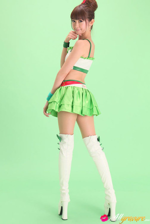 Bird in a green skirt and white boots posing in front of a green background. - XXXonXXX - Pic 3