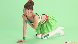 Bird in a green skirt and white boots posing in front of a green background. - XXXonXXX - Pic 10