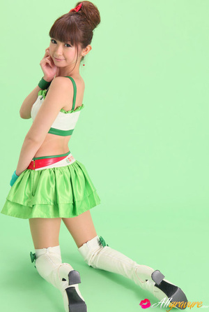 Bird in a green skirt and white boots posing in front of a green background. - XXXonXXX - Pic 12
