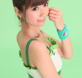 Bird in a green skirt and white boots posing in front of a green background.