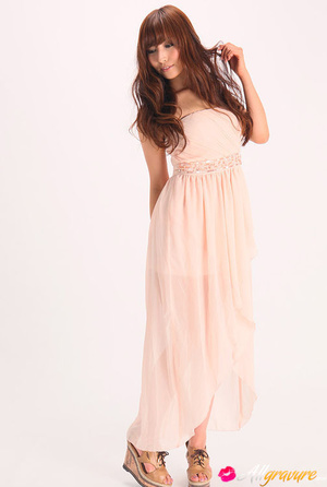 Vamp poses in her pink dress and wedges against a white background. - Picture 4