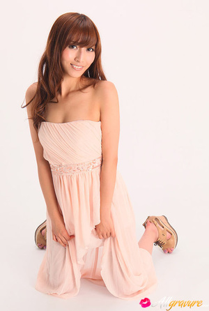 Vamp poses in her pink dress and wedges against a white background. - Picture 7