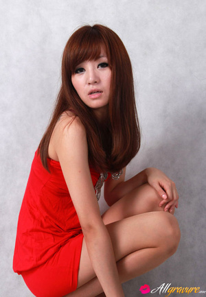 Female in a red dress and black heels poses against a grey background. - Picture 9