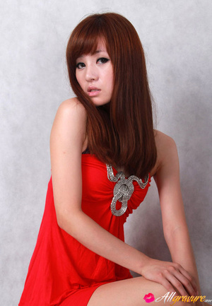 Female in a red dress and black heels poses against a grey background. - Picture 10