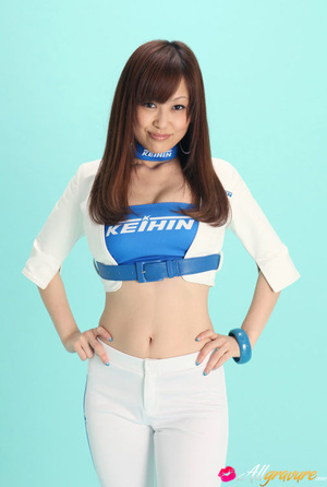 Nympho in white boots and pants posing in front of a blue background. - Picture 1