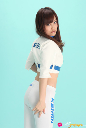 Nympho in white boots and pants posing in front of a blue background. - Picture 3