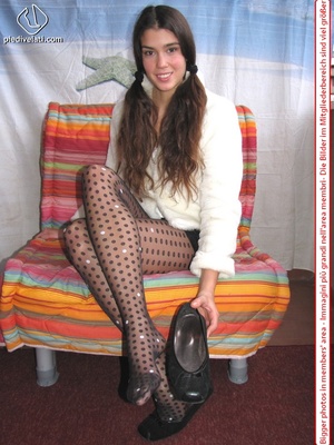Playful brunette freshie in a white blouse teasing you with her slim legs in polka-dot tights - Picture 8