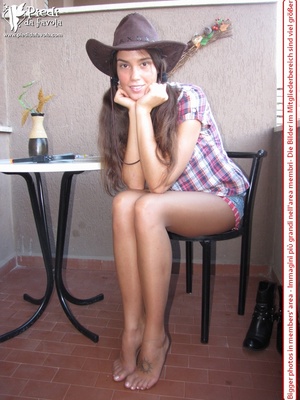 Little brunette pigtailed cowgirl wearing a hat, checked shirt and pantyhose looking dangerous with her gun - Picture 9