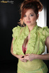 Alluring ponytailed redhead in a green suit and her enormous titties in