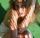 Sumptuous wench in a white frilly dress flashes near the beach.