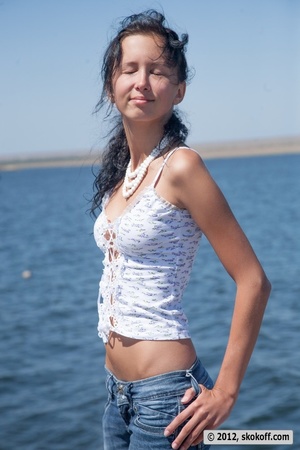 Adorable diva ditches her white top and blue jeans by the water. - Picture 3