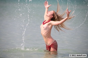 Fascinating vamp with a fishnet wrap playing nude in the water. - Picture 6