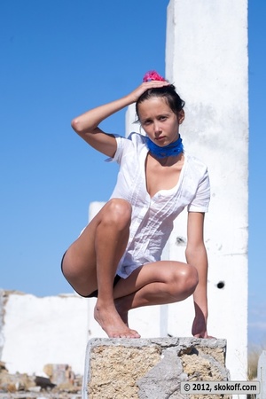 Enchanting damsel drops her white shirt and black shorts at some ruins. - Picture 3