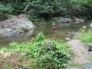 Naked swimmer sucks on a military guy’s knob by the water. - Picture 1