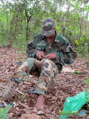 Gentleman in battle dress uniform lays down on fallen leaves to display his dick.