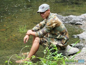 Two men in camo clothes chilling out by the river. - Picture 4