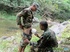 Men in military wear get into some homo oral sex near the water.
