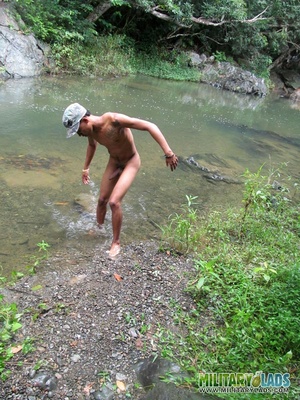 Young man drops his camo gear and gets in the river naked. - Picture 12