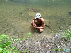 Young man drops his camo gear and gets in the river naked. - Picture 13