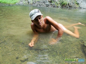 Hombre in a camo patrol cap posing naked near and in the river. - Picture 8