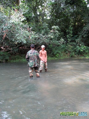 Guy in military uniform gets on his knees in the river to suck cock while jerking off. - XXXonXXX - Pic 2