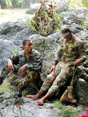 Resting on some rocks turns into a BJ session for a couple of military men. - Picture 1