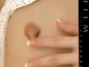 Arousing blondie in a white crocheted dress playing with a glass dildo